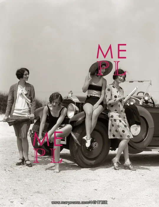 : Group of four women at shore gathered around : Group of four women at shore gathered around