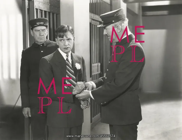 : Guard removing handcuffs from prisoner : Guard removing handcuffs from prisoner