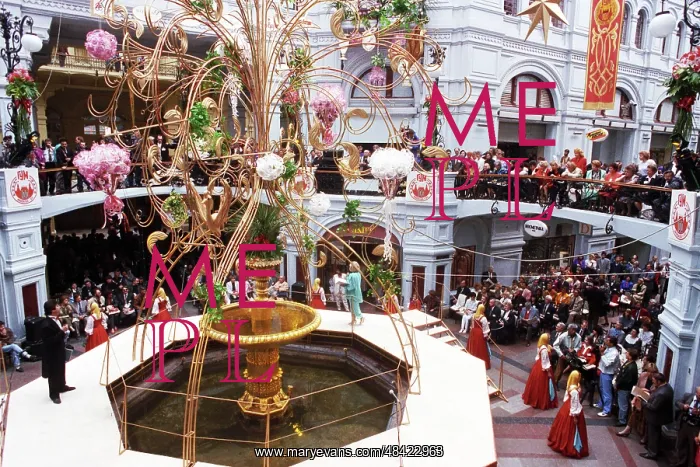  : GUM, 1993. Moscow. Russia. Customers attend an entertainment dedicated