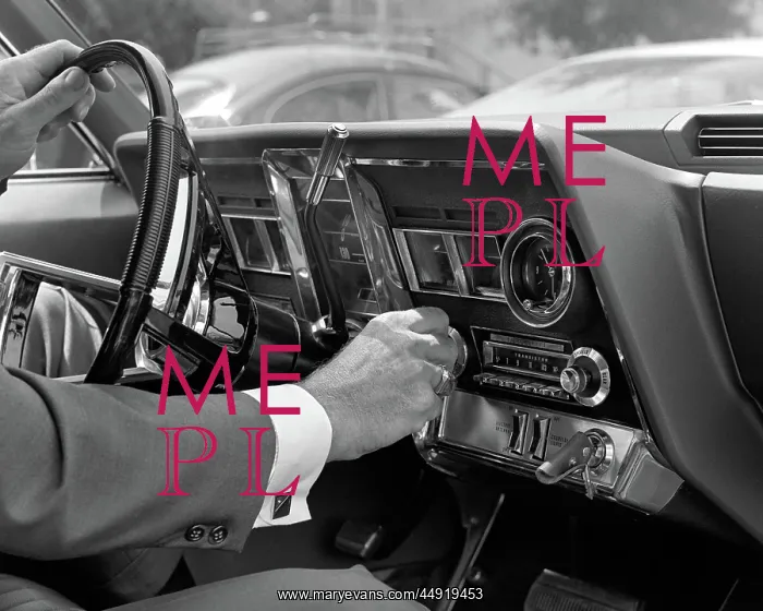 : Hand on car radio dials and steering wheel : Hand on car radio dials and steering wheel