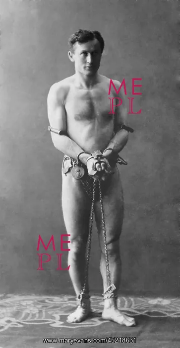 : Harry Houdini, escapologist, in chains : Harry Houdini, escapologist, in chains