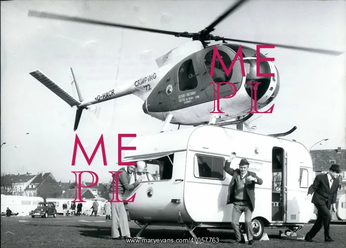 : Helicopter lands on caravan at German camping exhibition : Helicopter lands on caravan at German camping exhibition