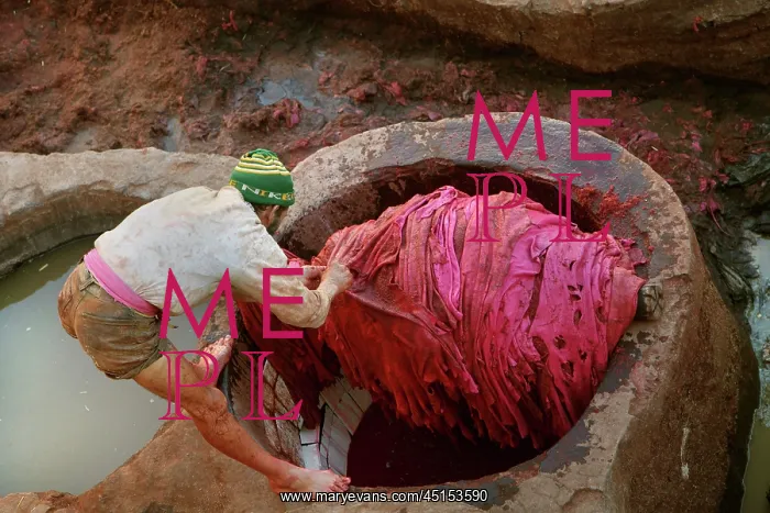 : Fez. High angle view of barefoot worker in vats : Fez. High angle view of barefoot worker in vats