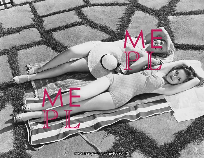 : High angle view of two young women lying on a towel : High angle view of two young women lying on a towel