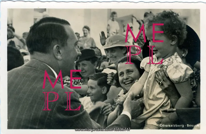 : Hitler greeting a small child in a crowd : Hitler greeting a small child in a crowd
