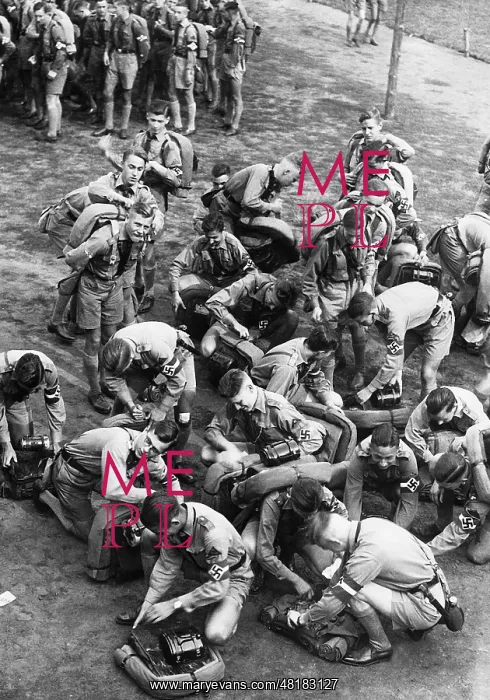 : Hitler Youth members pack up their knapsacks, 1937 : Hitler Youth members pack up their knapsacks, 1937