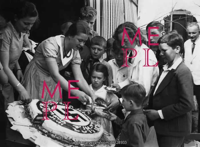 : Hitler's birthday cake is being shared, 1934 : Hitler's birthday cake is being shared, 1934