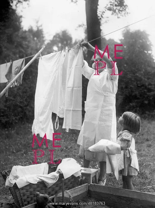 : Housewife hangs up laundry : Housewife hangs up laundry