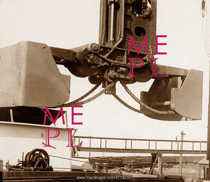 : A Hughlett clam-shell hoist unloading a ship's : A Hughlett clam-shell hoist unloading a ship's