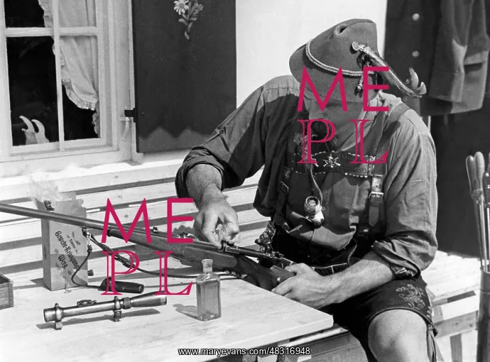 : Hunter cleaning the weapon, 1930s : Hunter cleaning the weapon, 1930s