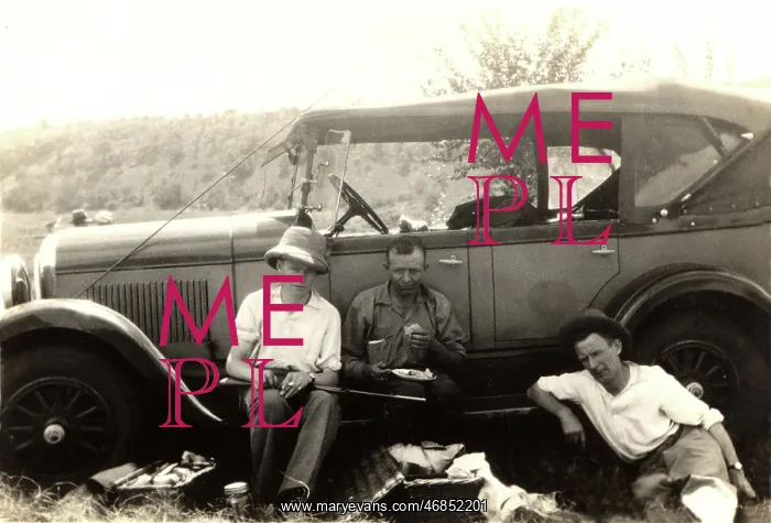 : Hunting party have a picnic by their car : Hunting party have a picnic by their car