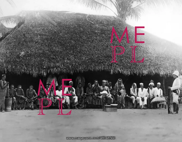 : In front of the hut of a village elder in German : In front of the hut of a village elder in German