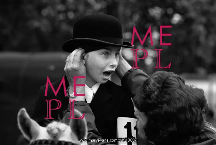 : Hyde Park young pony rider with hat being adjusted : Hyde Park young pony rider with hat being adjusted