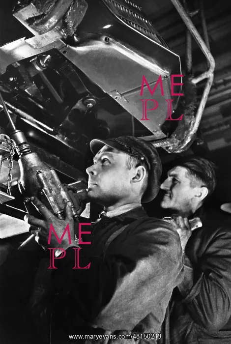 : Industrial workers assembling an engine : Industrial workers assembling an engine