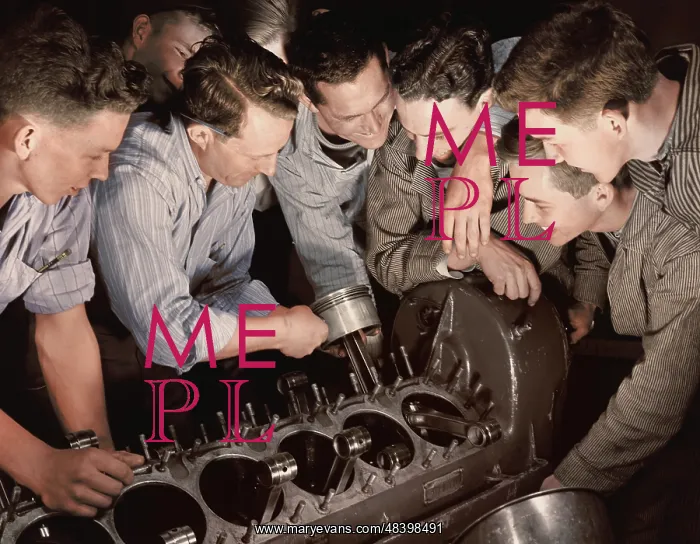 : Instructor showing a group of men how to assemble : Instructor showing a group of men how to assemble