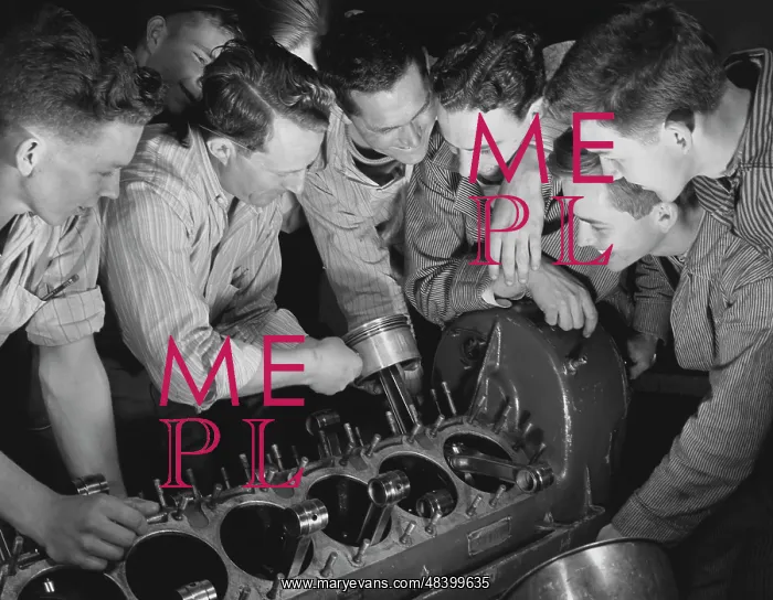 : Instructor showing a group of men how to assemble : Instructor showing a group of men how to assemble