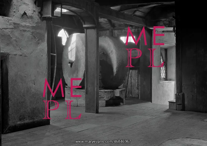: Interior of a mill with two millstones : Interior of a mill with two millstones