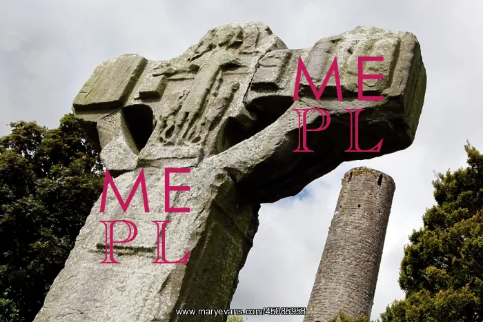 : Ireland. Low angle view of unfinished cross and round tower in the background : Ireland. Low angle view of unfinished cross and round tower in the background