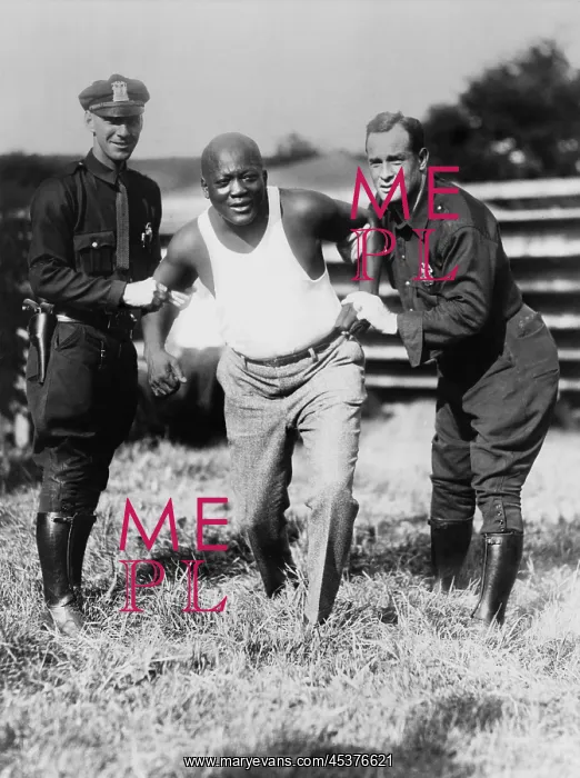 : Jack Johnson, being held by two police officers : Jack Johnson, being held by two police officers