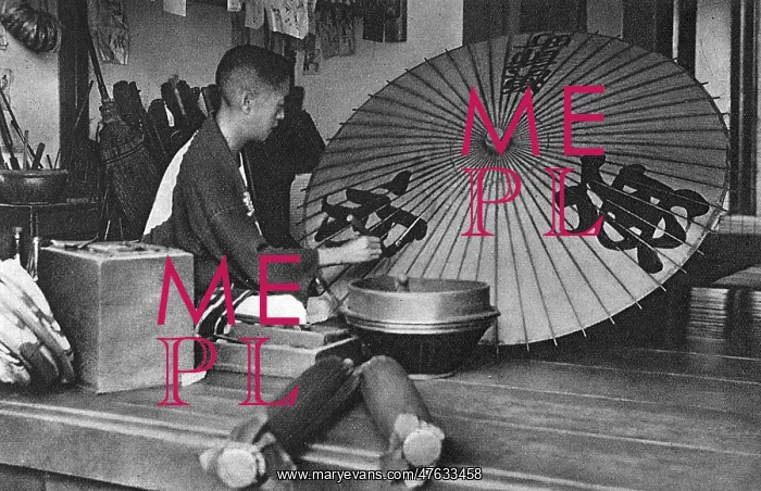 : A Japanese man paints an umbrella : A Japanese man paints an umbrella