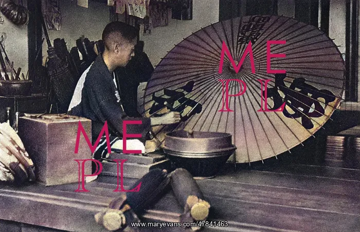 : A Japanese man paints an umbrella : A Japanese man paints an umbrella