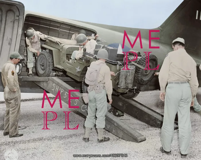 : A jeep is being loaded into a plane, circa 1942 : A jeep is being loaded into a plane, circa 1942