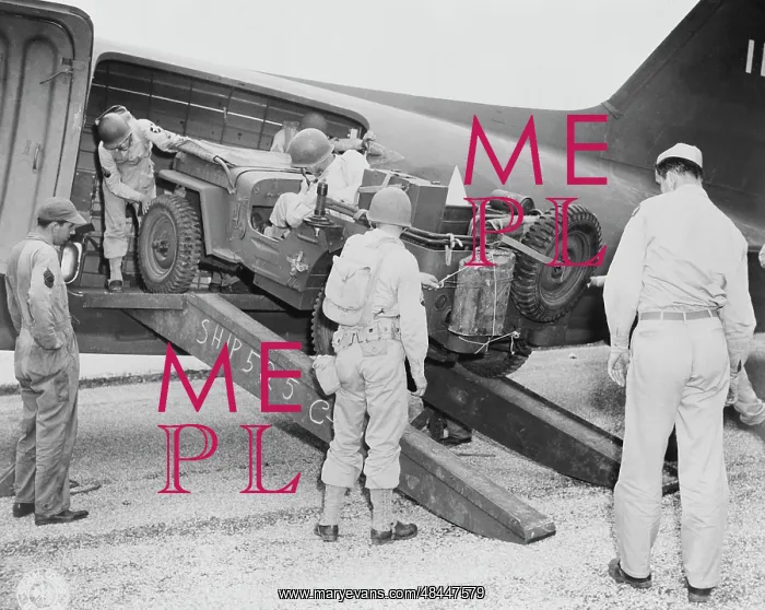 : A jeep is being loaded into a plane, circa 1942 : A jeep is being loaded into a plane, circa 1942