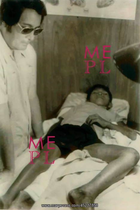 : Jim Jones standing over a Guyanese boy with ? : Jim Jones standing over a Guyanese boy with ?