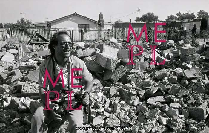 : Joao Silva sitting amongst building rubble, cameras : Joao Silva sitting amongst building rubble, cameras
