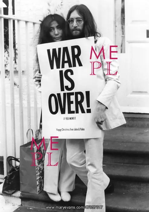 : John Lennon and Yoko Ono with War Is Over poster : John Lennon and Yoko Ono with War Is Over poster