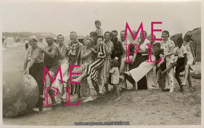 : A very jolly group playing with a huge ball on the beach : A very jolly group playing with a huge ball on the beach