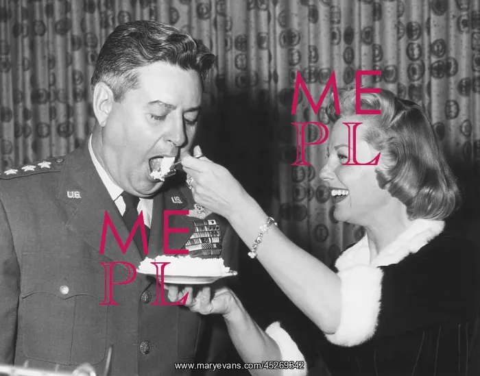 : June Allyson serving cake to General Curtis LeMay : June Allyson serving cake to General Curtis LeMay