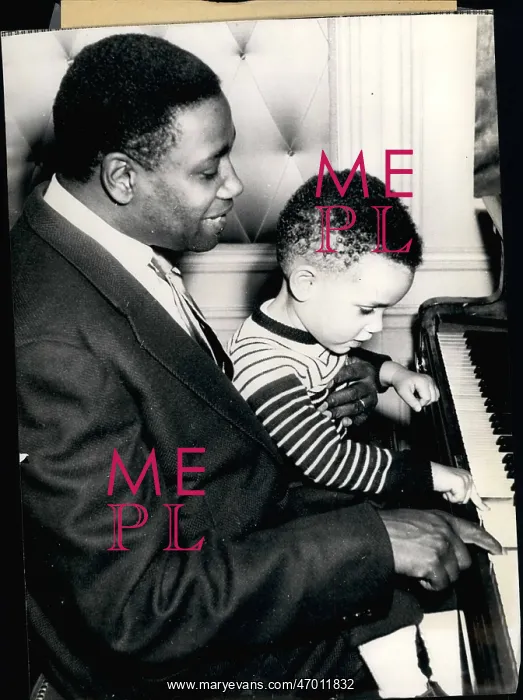 : Kenneth Spencer, opera singer, with son at the piano : Kenneth Spencer, opera singer, with son at the piano