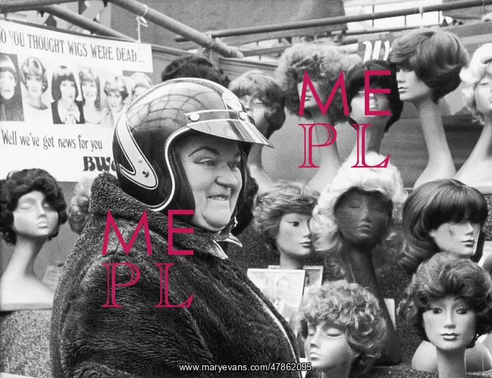 : Lady in motorcycle helmet by wig stall : Lady in motorcycle helmet by wig stall