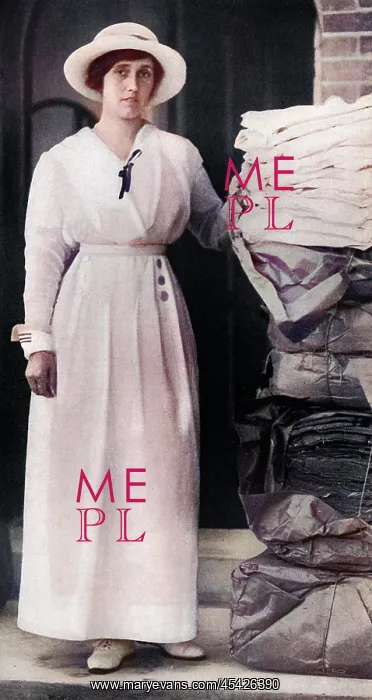 : Lady Quilter with pile of comforts for troops, WW1 : Lady Quilter with pile of comforts for troops, WW1