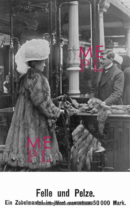 : Lady trying on a coat, 1908 : Lady trying on a coat, 1908