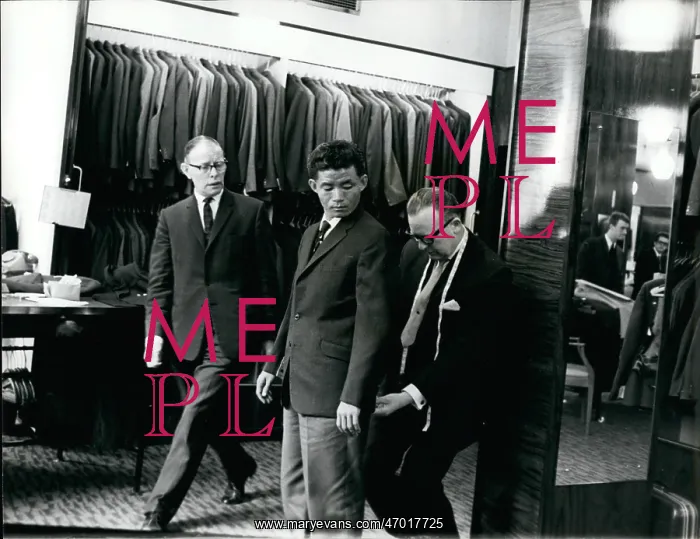 : Lance Corporal Rambahadur Limbu trying on a suit : Lance Corporal Rambahadur Limbu trying on a suit