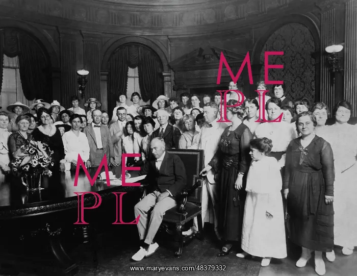 : A large group, mostly women, standing around a : A large group, mostly women, standing around a