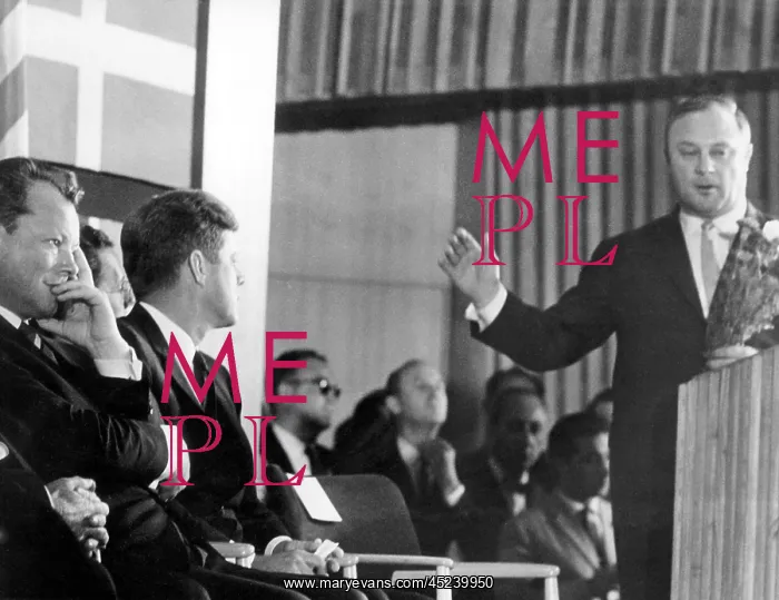 : Leber hands over a bunch of carnations to Kennedy : Leber hands over a bunch of carnations to Kennedy
