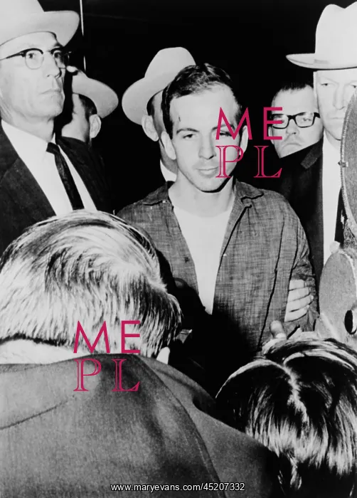 : Lee Harvey Oswald escorted by officers at ? : Lee Harvey Oswald escorted by officers at ?