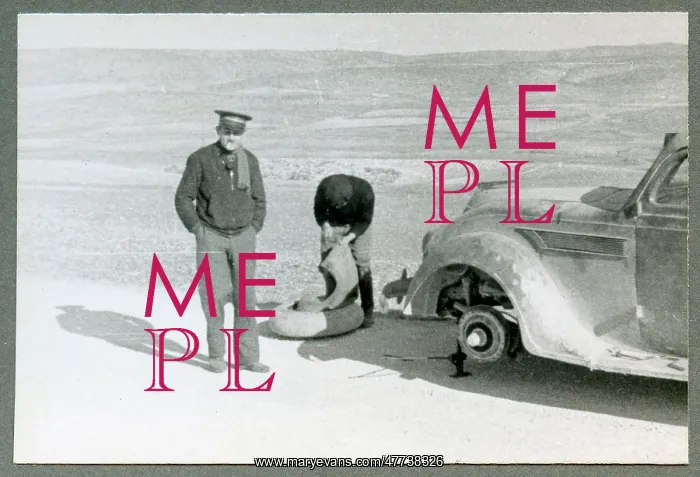 : Len Crome and His Driver Edenhoffer Chaning a Wheel : Len Crome and His Driver Edenhoffer Chaning a Wheel