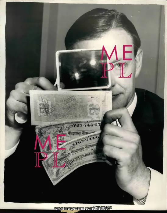 : Leonard Mountford examines travellers cheques for AmEx : Leonard Mountford examines travellers cheques for AmEx