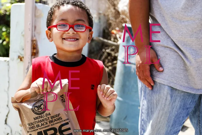 : A little boy with army rations distributed in San : A little boy with army rations distributed in San