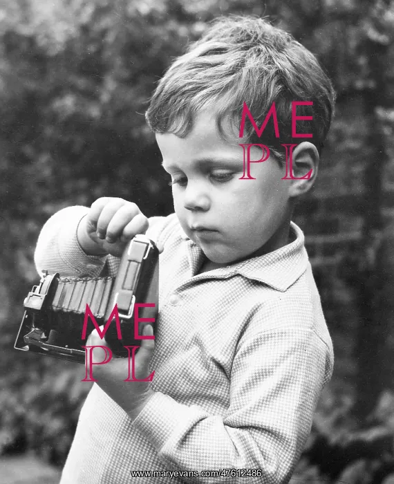 : Little boy with a camera in a garden : Little boy with a camera in a garden