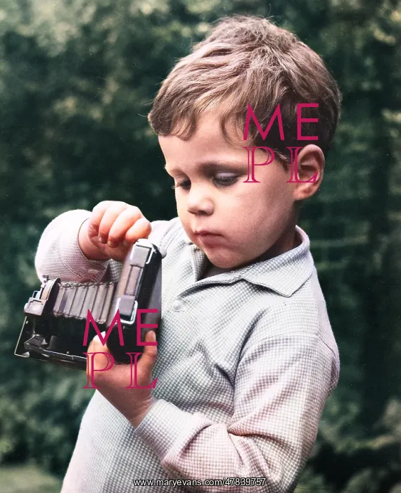  : Little boy with a camera in a garden