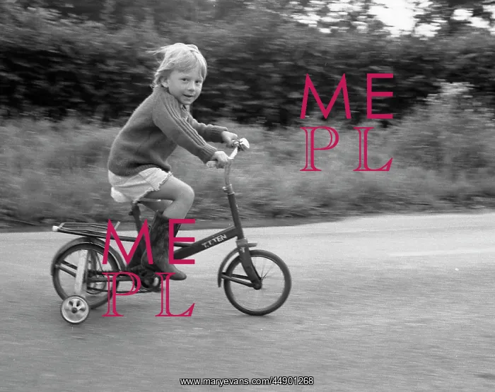 : Little boy riding bicycle with stabilisers : Little boy riding bicycle with stabilisers