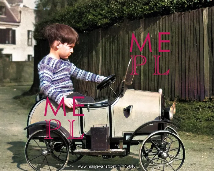  : Little boy riding in a toy car