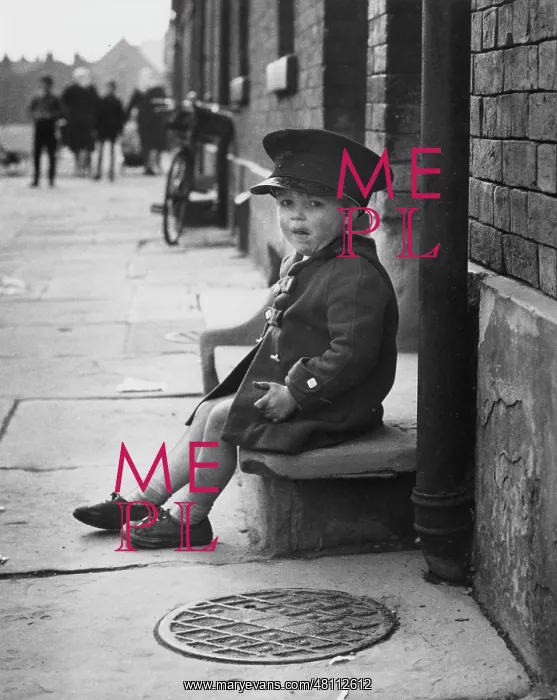 : Little boy sitting on a doorstep : Little boy sitting on a doorstep