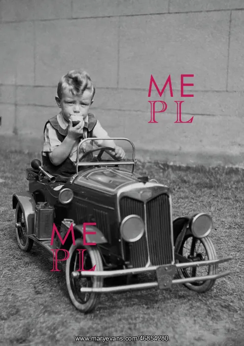 : Little boy sitting in a toy car : Little boy sitting in a toy car