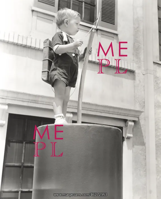: Little boy standing on giant firecracker prop : Little boy standing on giant firecracker prop
